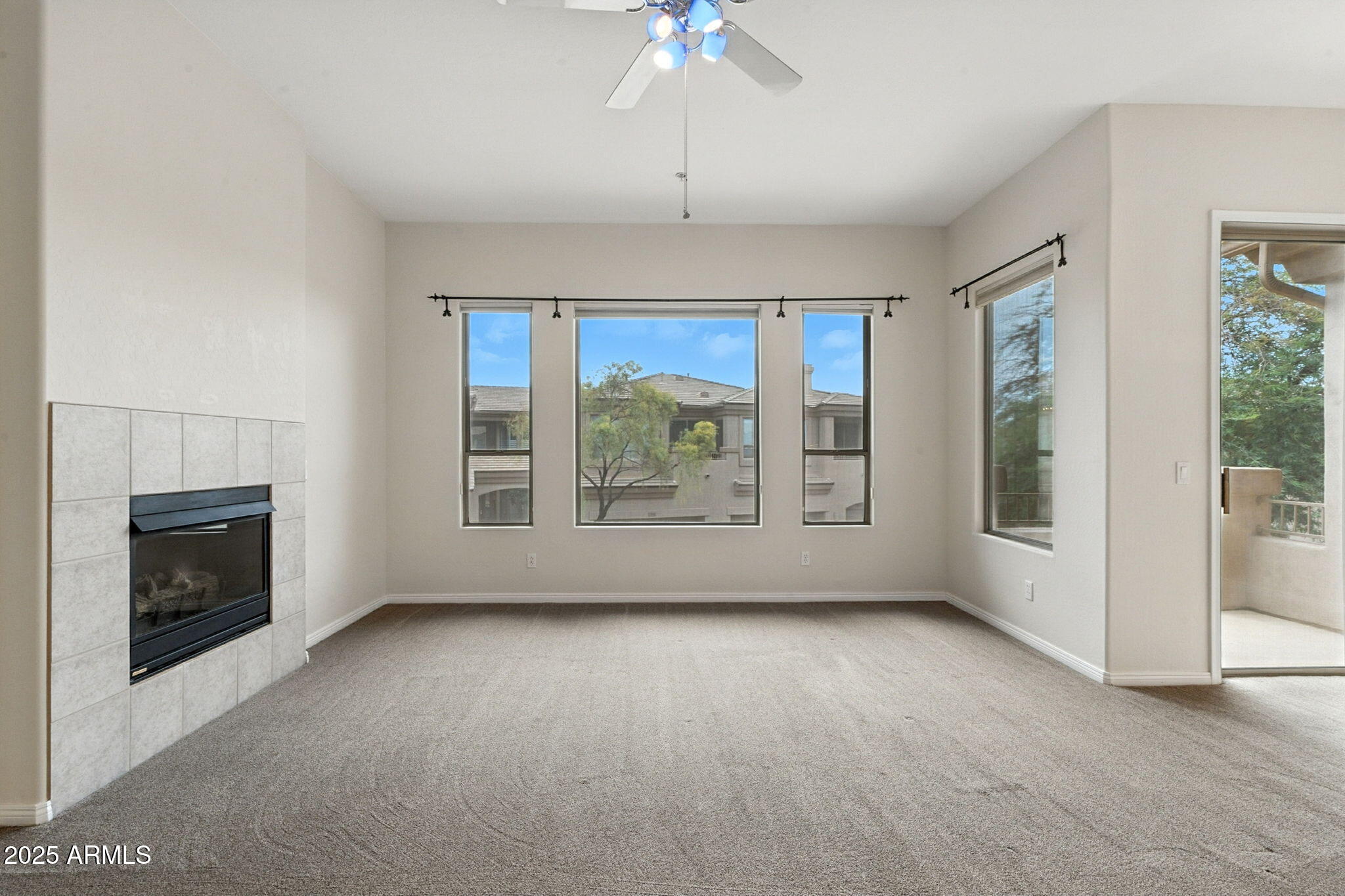 16420 North Thompson Peak Parkway, Unit 2031 Scottsdale, AZ 85260 - Photo 6 of 30 an empty room with windows and fireplace