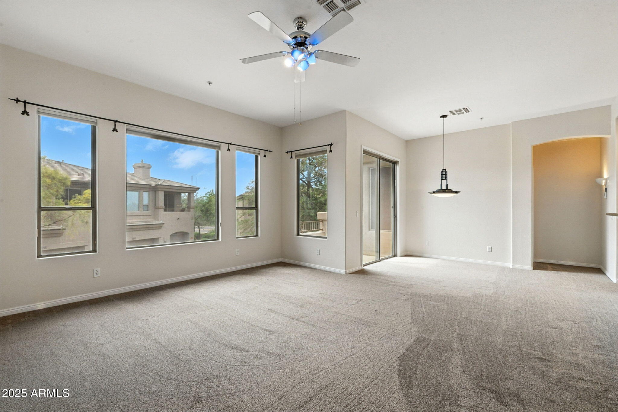 16420 North Thompson Peak Parkway, Unit 2031 Scottsdale, AZ 85260 - Photo 7 of 30 a view of an empty room with a window and a kitchen