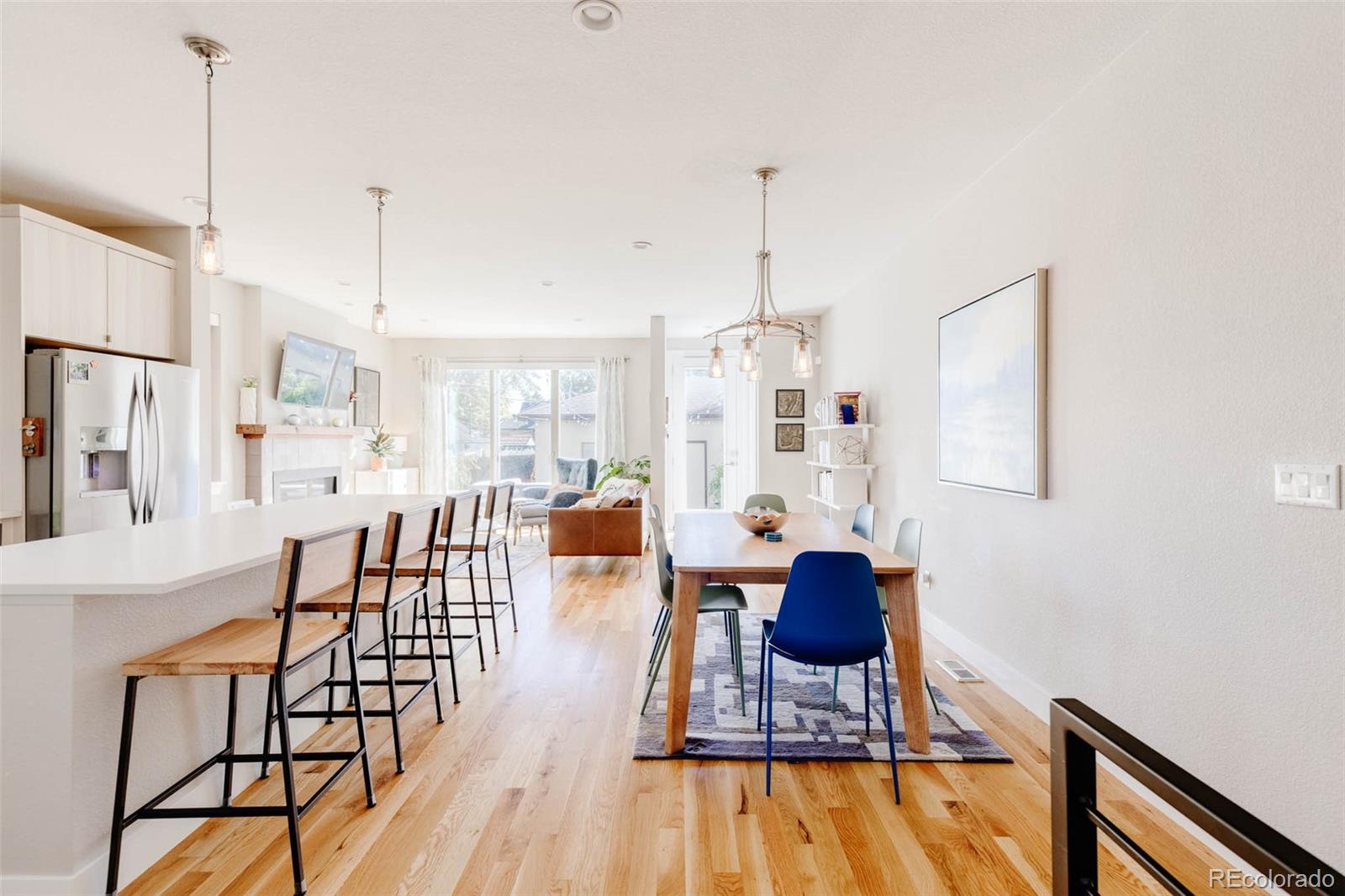 3738 Raleigh Street Denver, CO 80212 - Photo 11 of 34 a view of a dining room with furniture wooden floor and chandelier