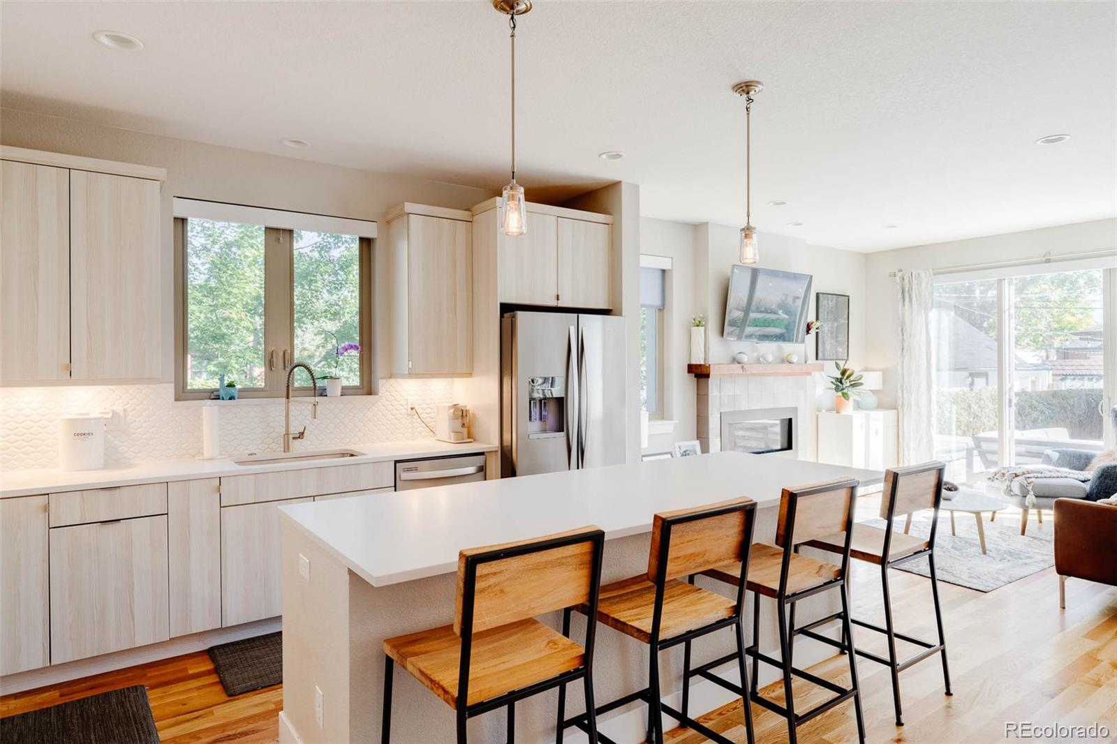 3738 Raleigh Street Denver, CO 80212 - Photo 13 of 34 a kitchen with stainless steel appliances granite countertop a stove a sink a refrigerator a table and chairs