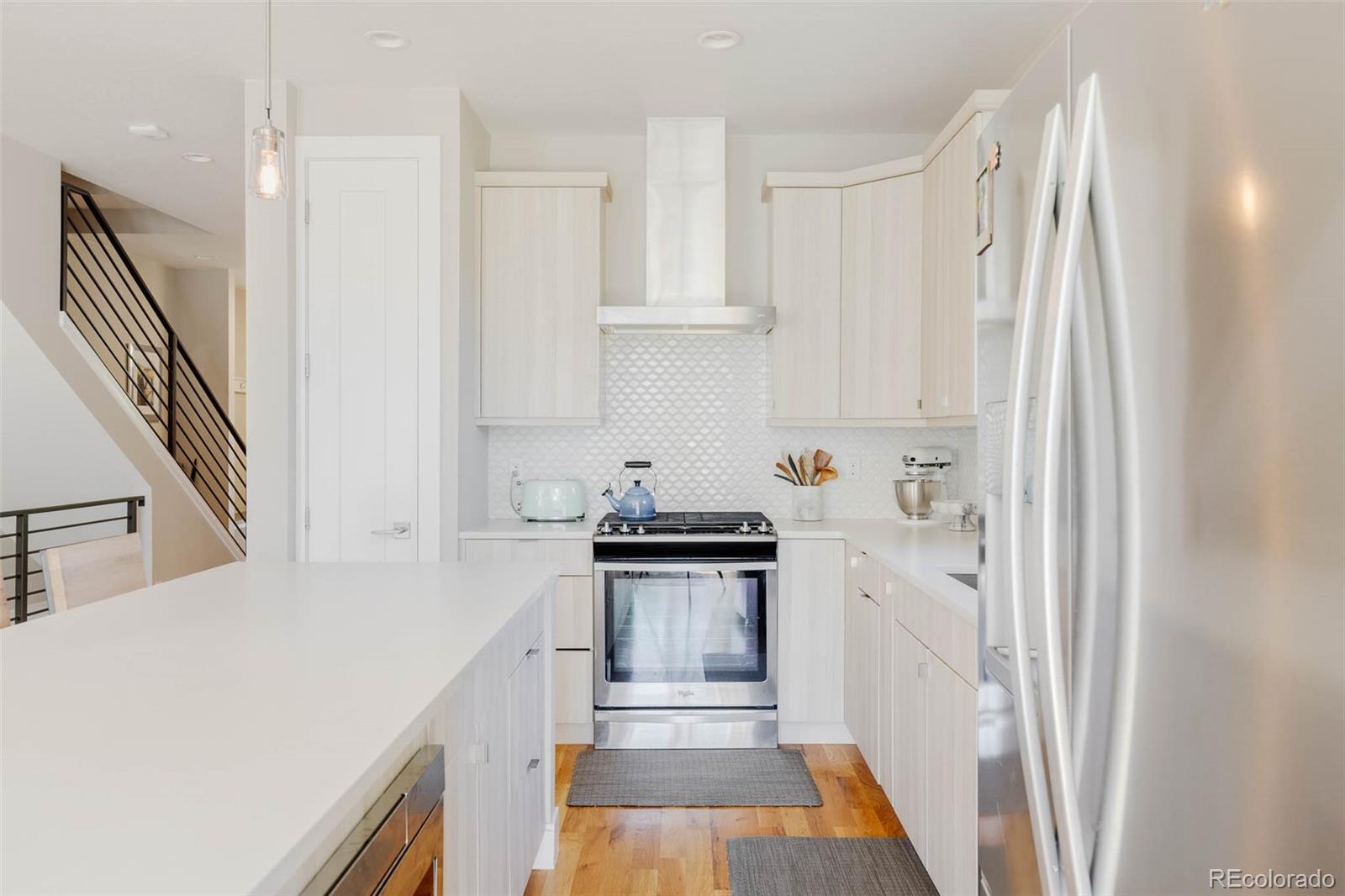 3738 Raleigh Street Denver, CO 80212 - Photo 15 of 34 a kitchen with stainless steel appliances a stove a refrigerator and cabinets