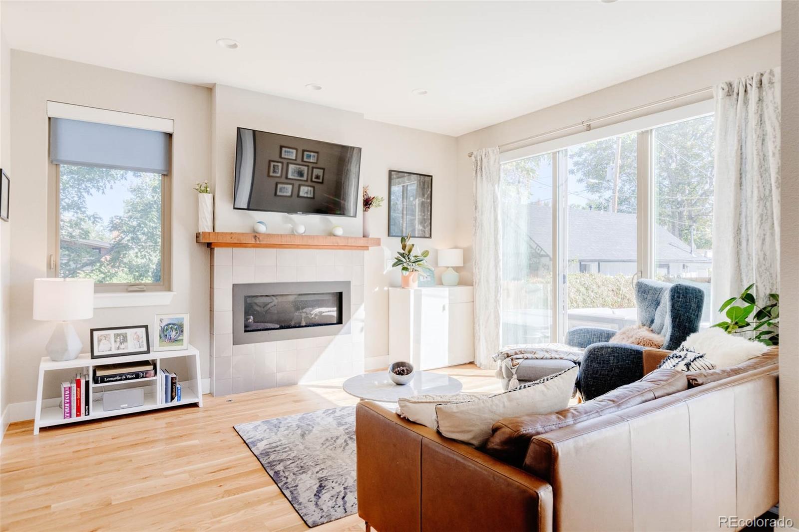 3738 Raleigh Street Denver, CO 80212 - Photo 16 of 34 a living room with furniture and a fireplace