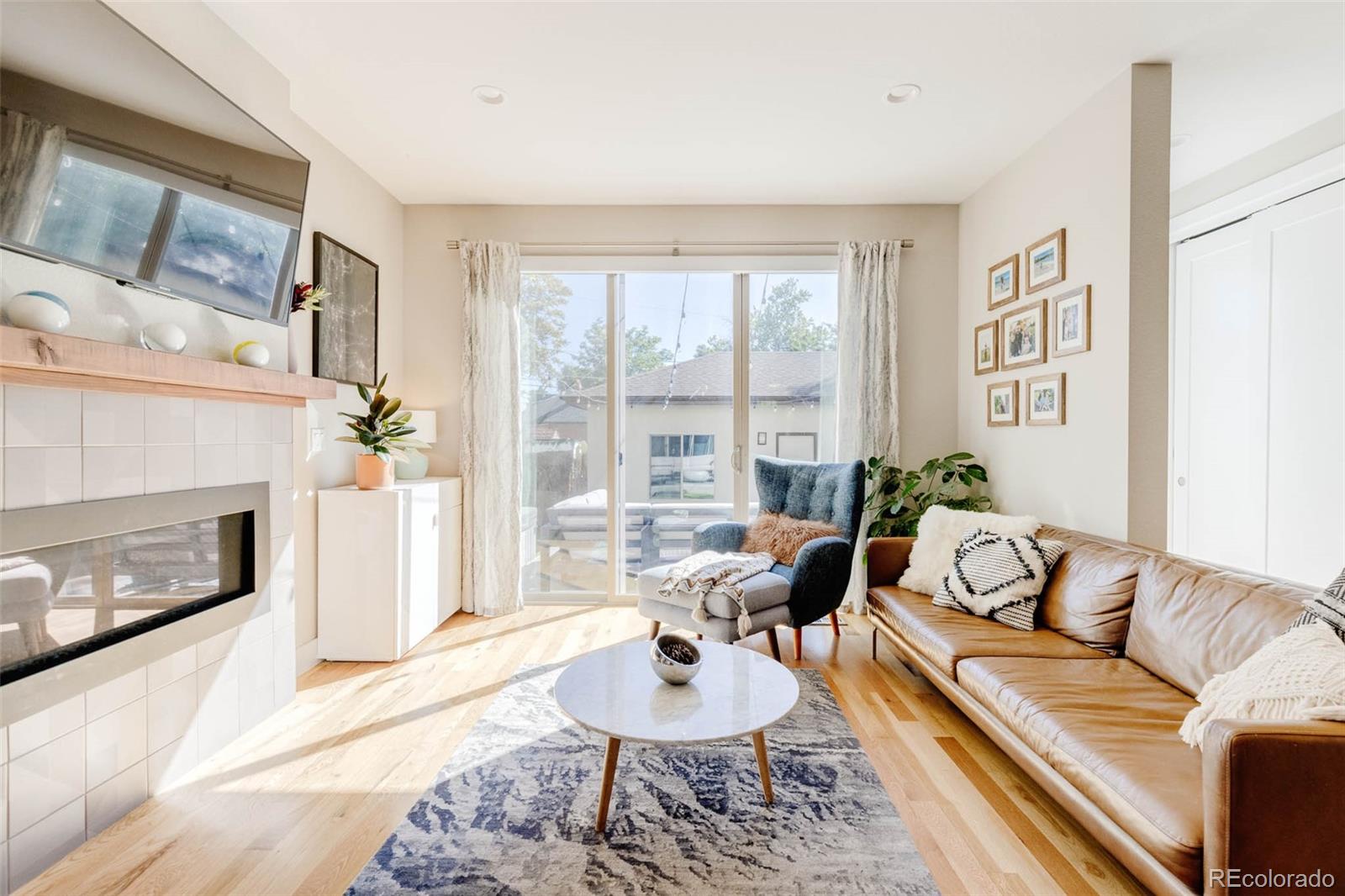 3738 Raleigh Street Denver, CO 80212 - Photo 17 of 34 a living room with furniture and a fireplace