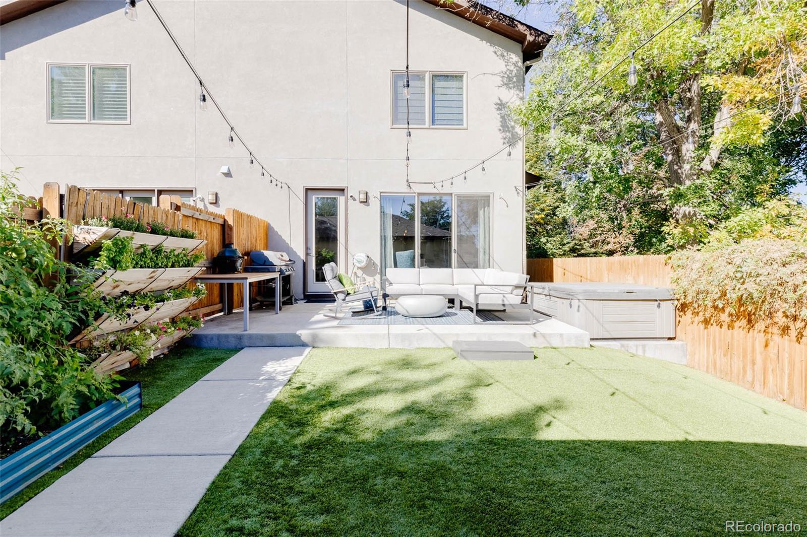 3738 Raleigh Street Denver, CO 80212 - Photo 19 of 34 a view of an house with backyard porch and furniture