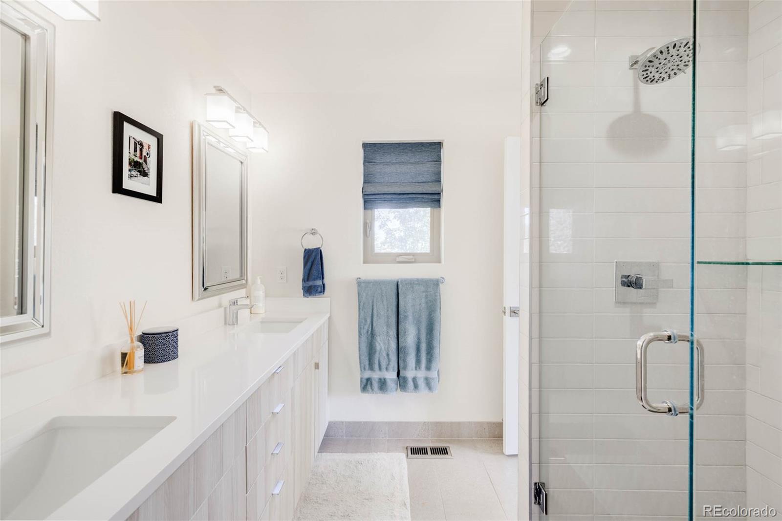 3738 Raleigh Street Denver, CO 80212 - Photo 22 of 34 a bathroom with a bathtub sink a mirror and shower