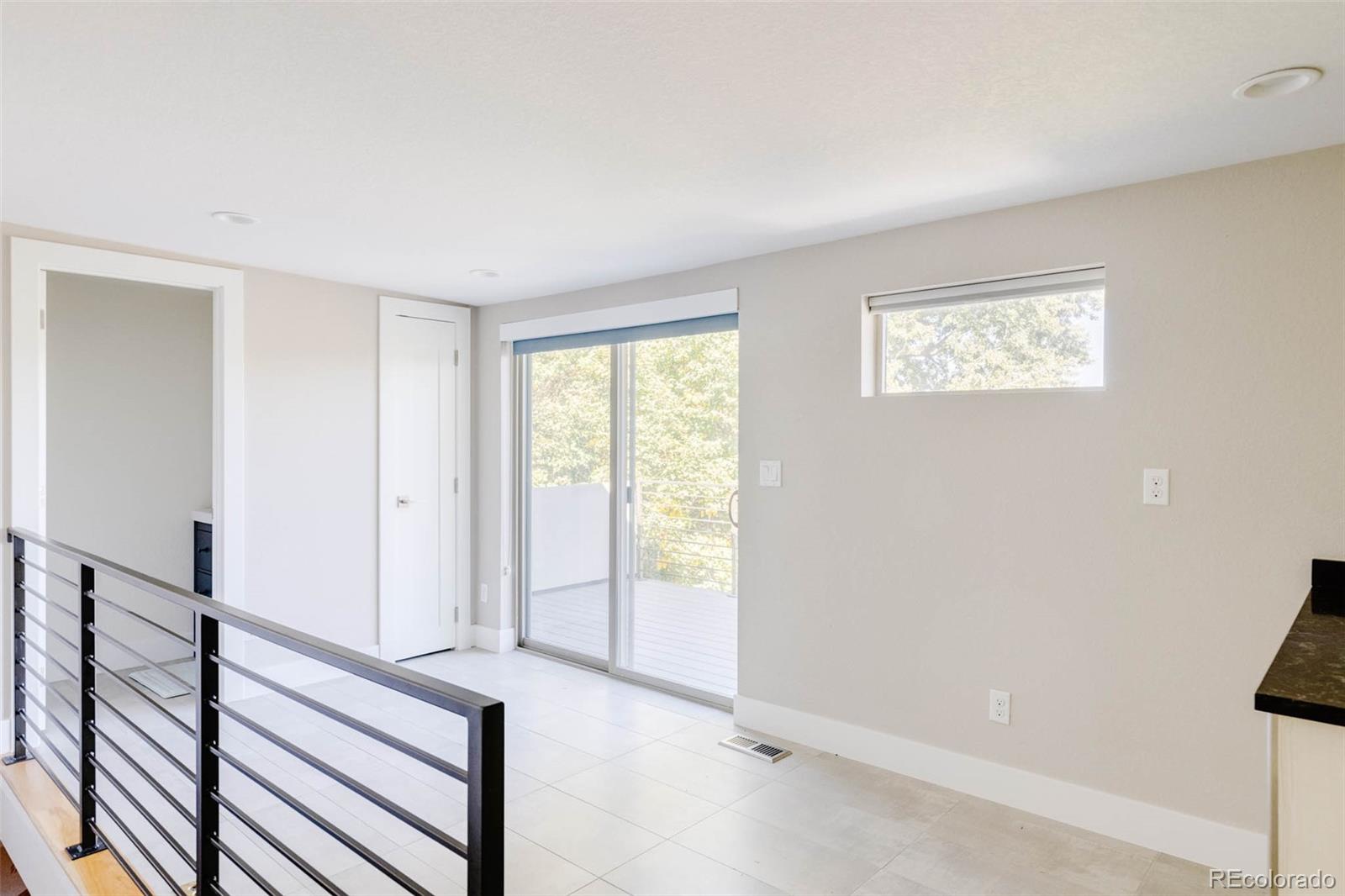 3738 Raleigh Street Denver, CO 80212 - Photo 28 of 34 a view of an empty room with wooden floor