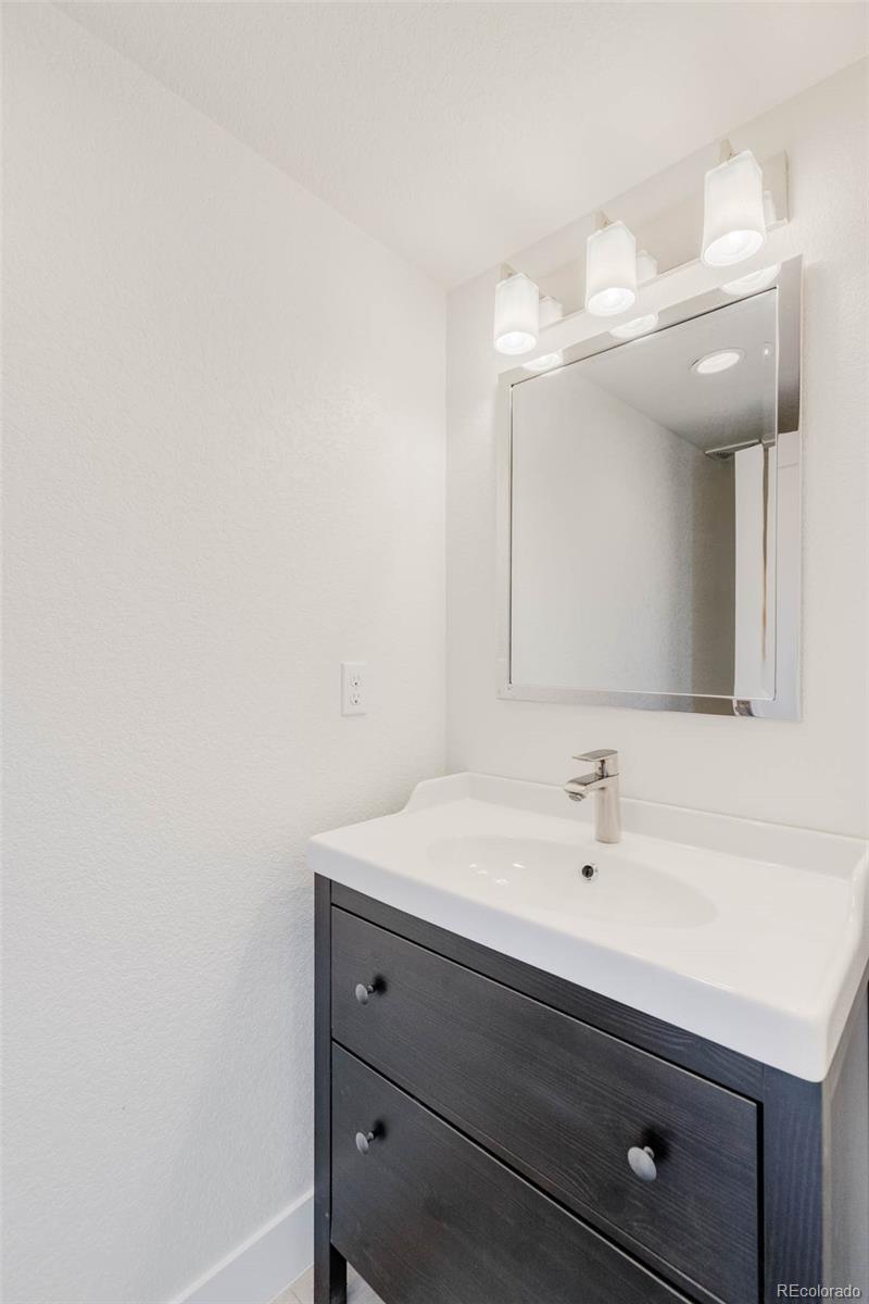 3738 Raleigh Street Denver, CO 80212 - Photo 29 of 34 a bathroom with a sink and a mirror