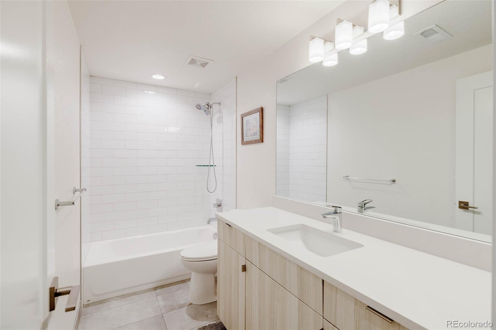 3738 Raleigh Street Denver, CO 80212 - Photo 33 of 34 a bathroom with a sink a toilet and shower
