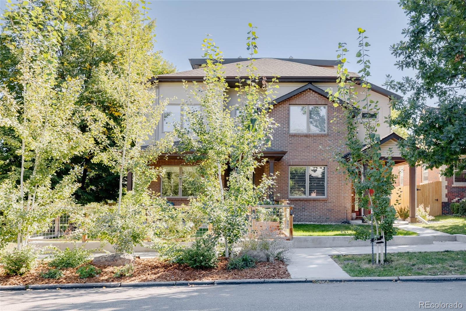 3738 Raleigh Street Denver, CO 80212 - Photo 4 of 34 a front view of a house with a yard and garage