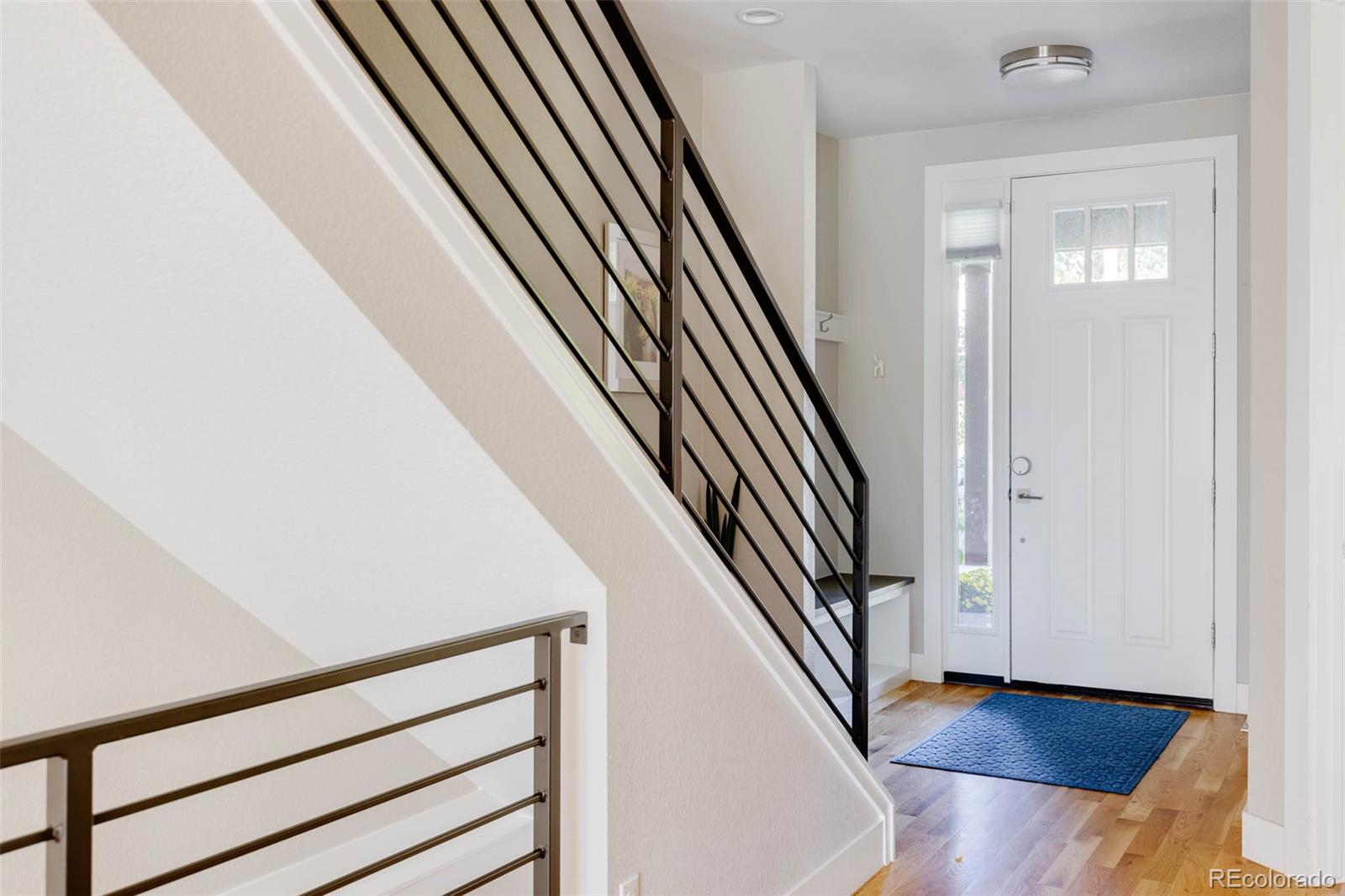 3738 Raleigh Street Denver, CO 80212 - Photo 6 of 34 a view of staircase with white walls and railing