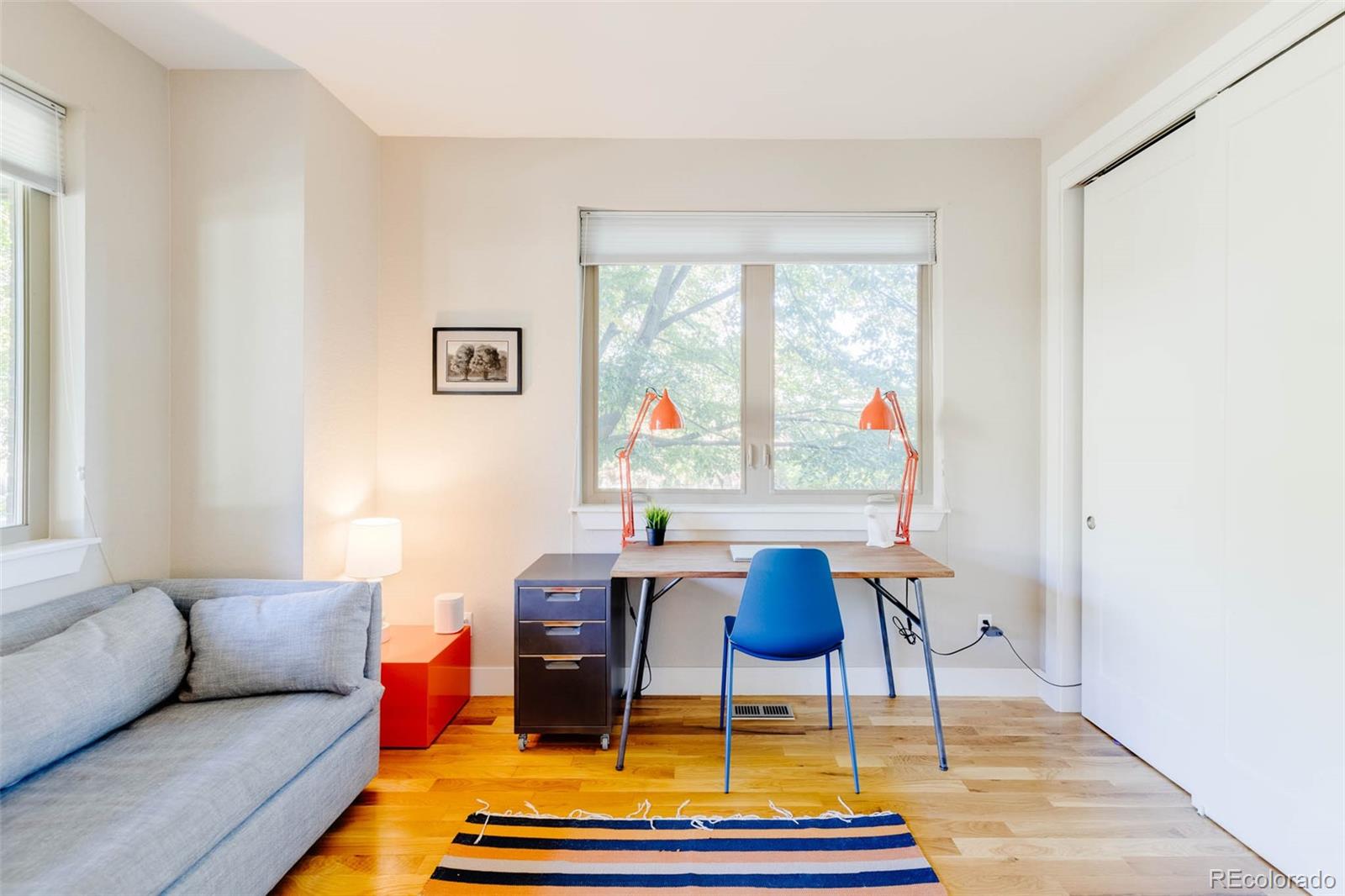 3738 Raleigh Street Denver, CO 80212 - Photo 9 of 34 a living room with furniture a table and a large window