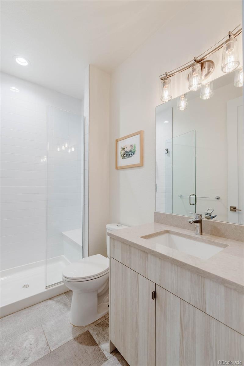 3738 Raleigh Street Denver, CO 80212 - Photo 10 of 34 a bathroom with a sink a toilet and shower