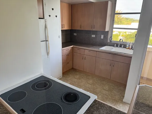 a kitchen with a refrigerator and a stove