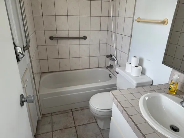 a bathroom with a sink a toilet and bathtub