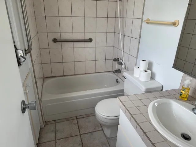 a bathroom with a sink a toilet and bathtub
