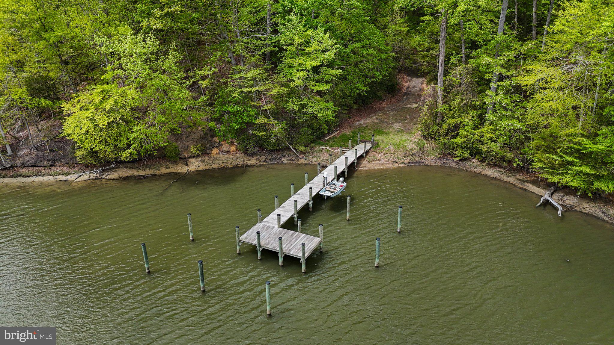43671 Sunny Ridge Lane Hollywood, MD 20636 - Photo 6 of 45 Serene dock nestled in lush greenery.