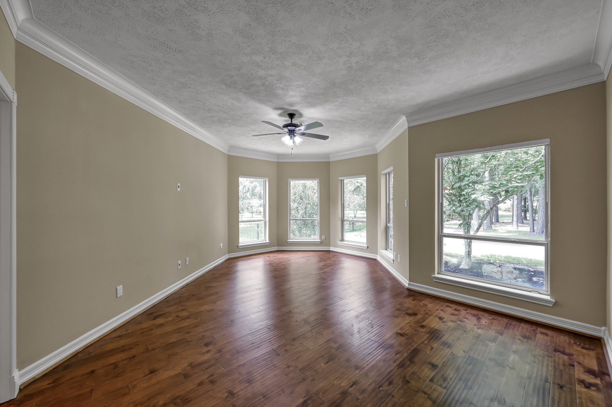 2205 Longmire Road Conroe, TX 77304 - Photo 22 of 49 Spacious primary bedroom downstairs. The windows and natural light are abundant throughout this beautiful home.