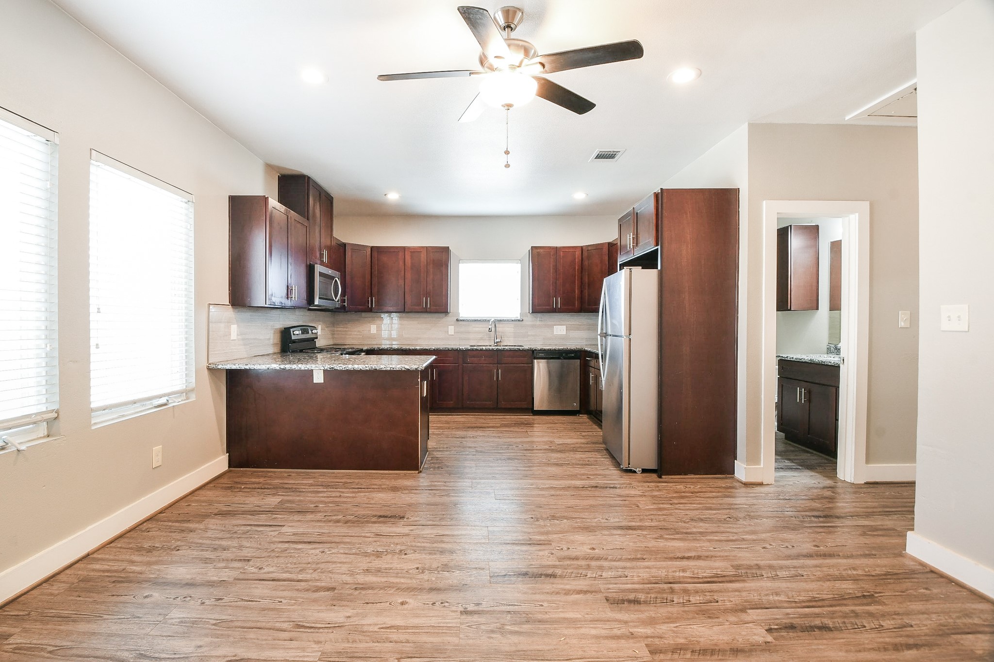 3249 Dixie Drive, Unit B Houston, TX 77021 - Photo 4 of 25 a kitchen with stainless steel appliances granite countertop a refrigerator and a stove top oven