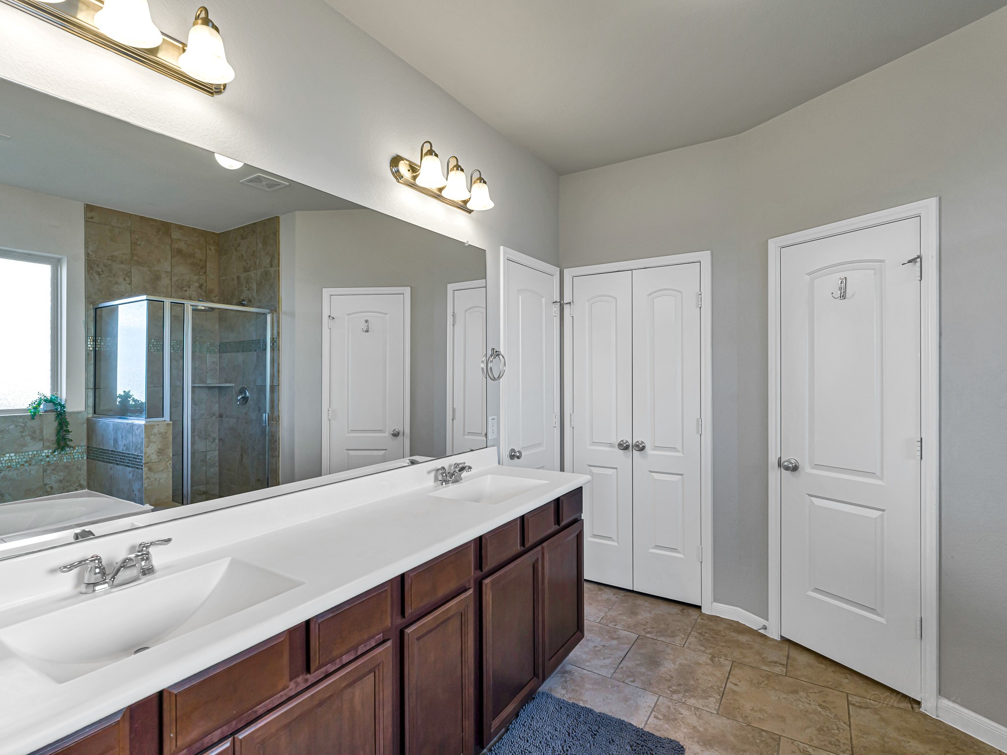 5622 Maxon Court Rosenberg, TX 77471 - Photo 16 of 23 See the size of your primary bath! Features dual sink vanities, ensuring a smooth and spacious morning routine! Very generous space and storage! Also features a privacy door, linen closet AND a spacious walk in closet with plenty of rods and built in shelves!