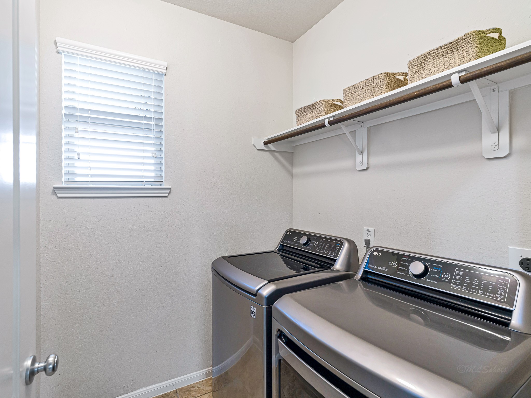 5622 Maxon Court Rosenberg, TX 77471 - Photo 20 of 23 The dedicated utility room is both bright and functional, featuring a window for natural light and built in shelving for easy organization!