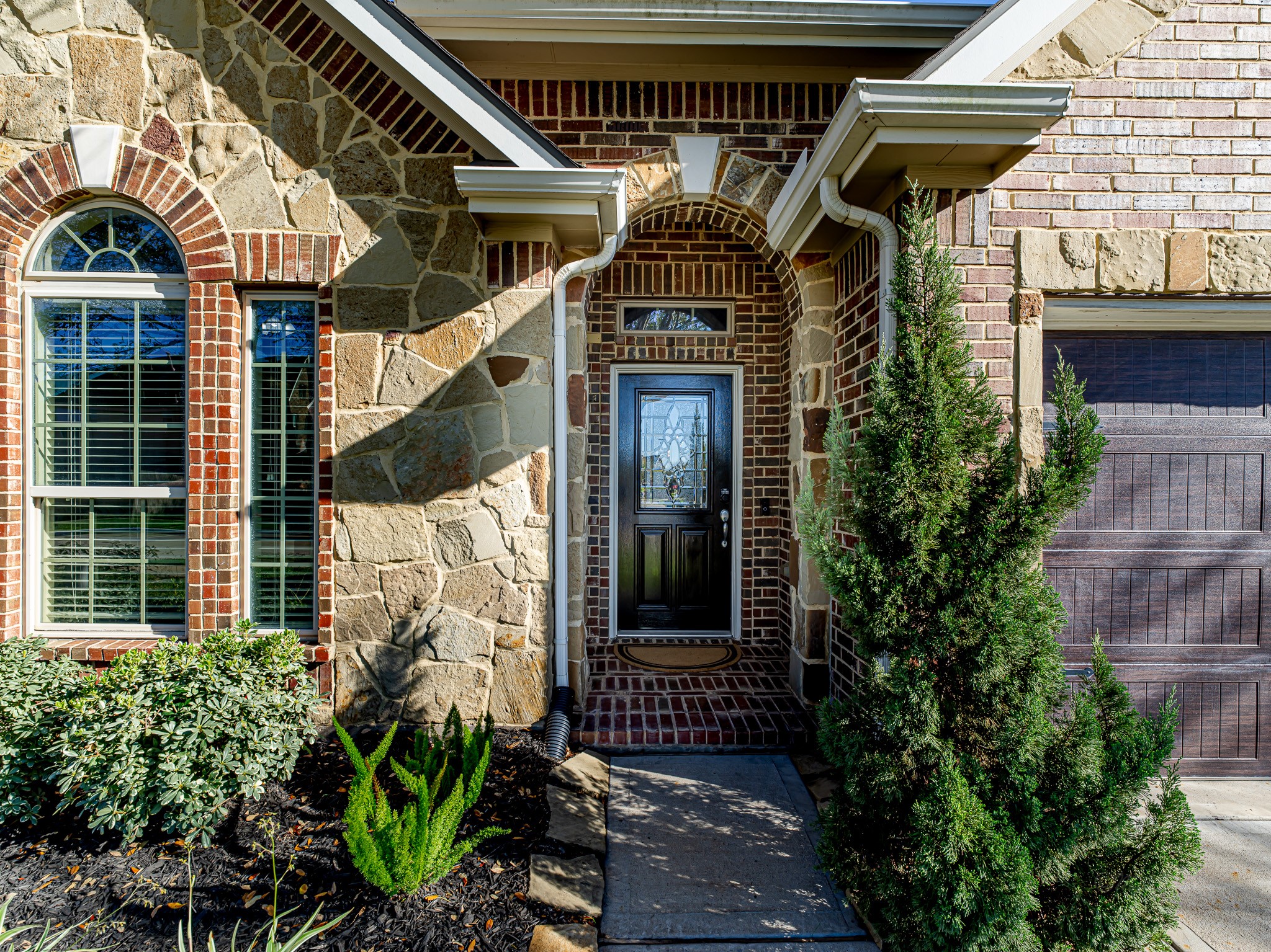 5622 Maxon Court Rosenberg, TX 77471 - Photo 3 of 23 Welcome your guests in style! Notice the intricate stonework and timeless brick arches that frame the entrance, perfectly highlighting the home's custom craftsmanship and curb appeal!