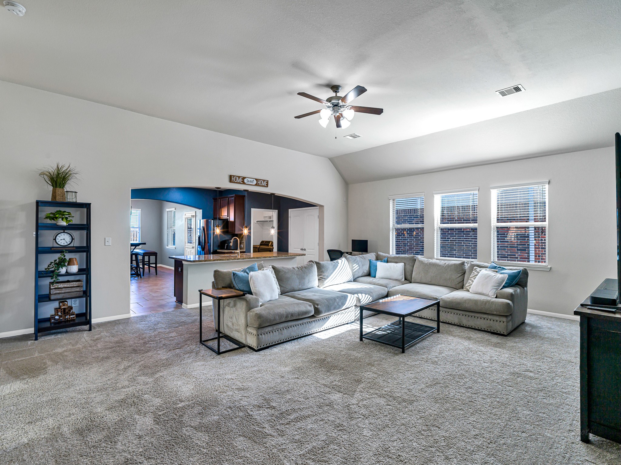 5622 Maxon Court Rosenberg, TX 77471 - Photo 5 of 23 Soaring vaulted ceilings and architectural arches create a grand, open-concept feel that flows seamlessly from the spacious living area into the kitchen and central island.