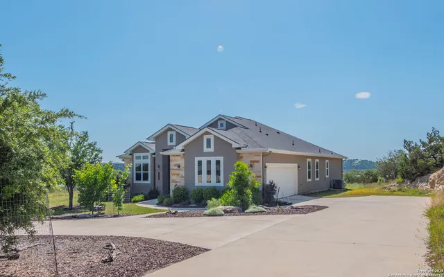 a front view of a house with a yard and a garage