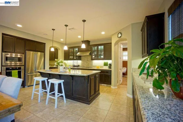 a large kitchen with a table and chairs
