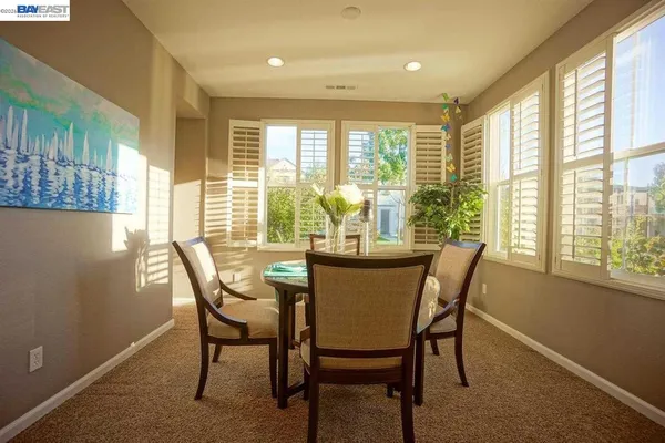 a view of a dining room with furniture and windows