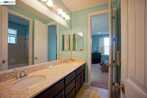 a bathroom with a sink double vanity and a mirror
