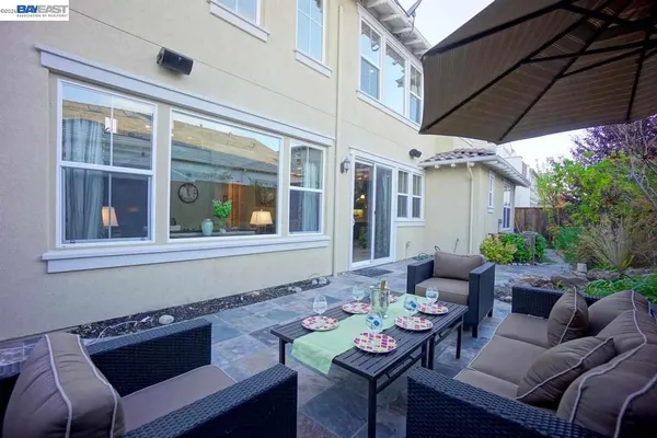a backyard of a house with outdoor seating