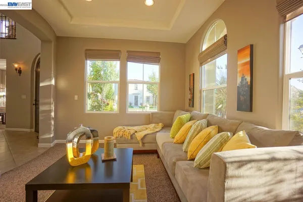 a bedroom with furniture and a large window