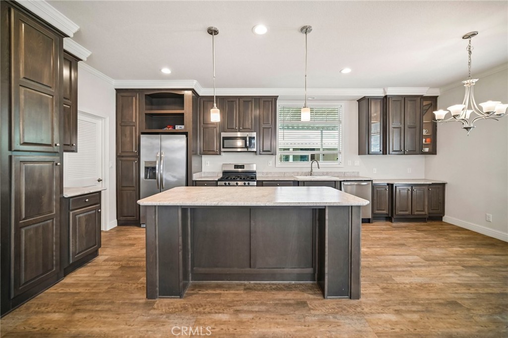 250 East Telegraph Road, Unit 307 Fillmore, CA 93015 - Photo 15 of 36 a kitchen with kitchen island a sink stainless steel appliances and cabinets