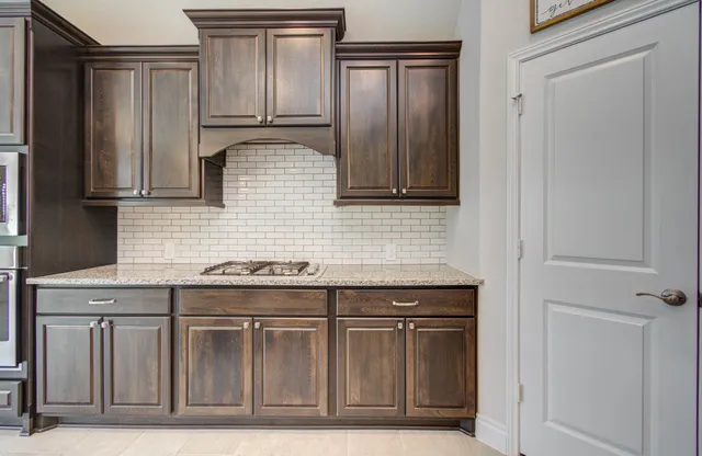 a kitchen with granite countertop a sink and cabinets