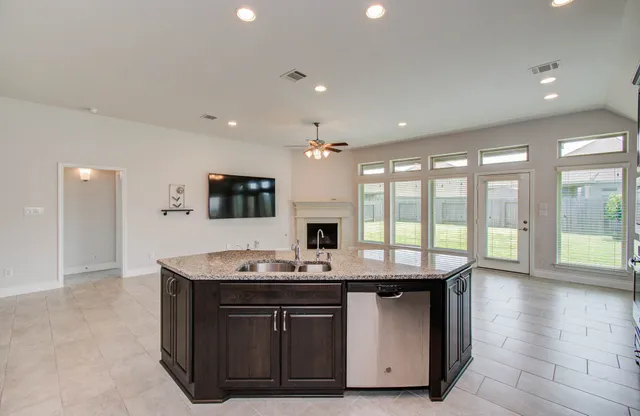 a kitchen with a sink stove and cabinets