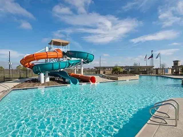 an outdoor space with swimming pool and furniture