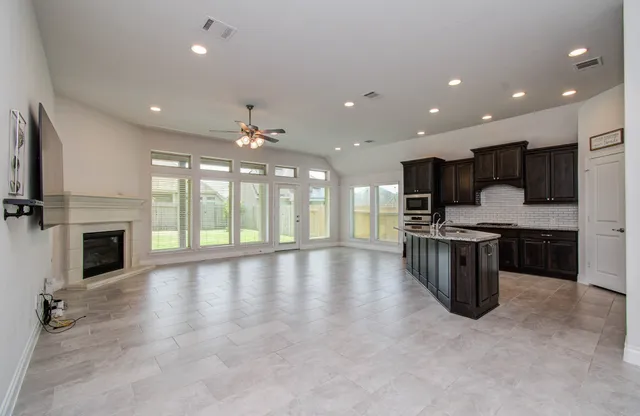 a large kitchen with stainless steel appliances granite countertop a large counter top stainless steel appliances and cabinets