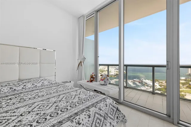 a bedroom with a large bed and a large window