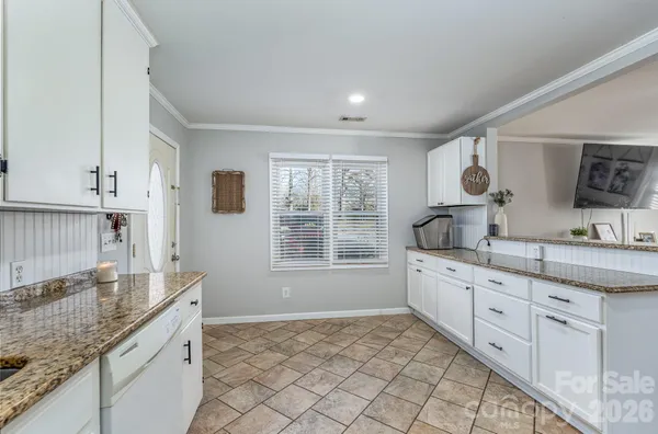 a large bathroom with a granite countertop sink and a window