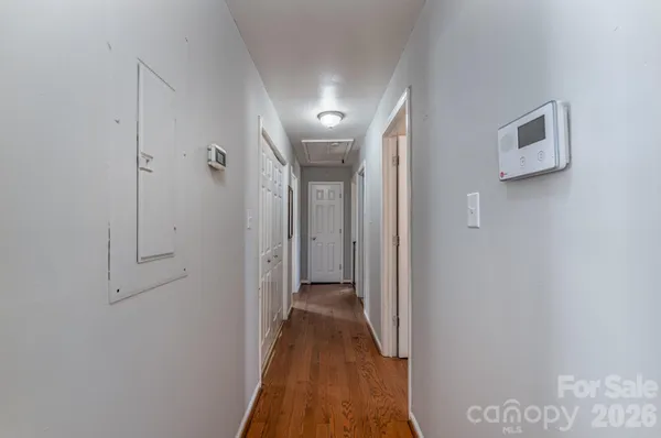 a view of a hallway with wooden floor