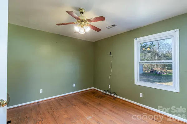 a view of room with window and ceiling fan
