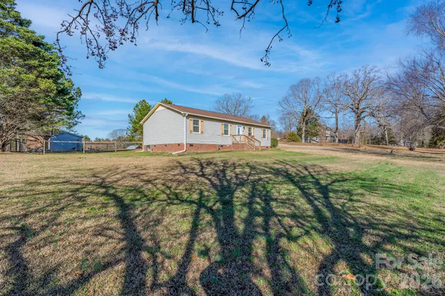 a view of a swimming pool with couches and a fire pit