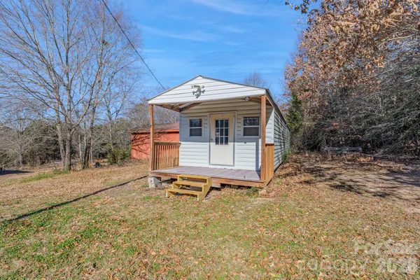 a view of a small house with backyard