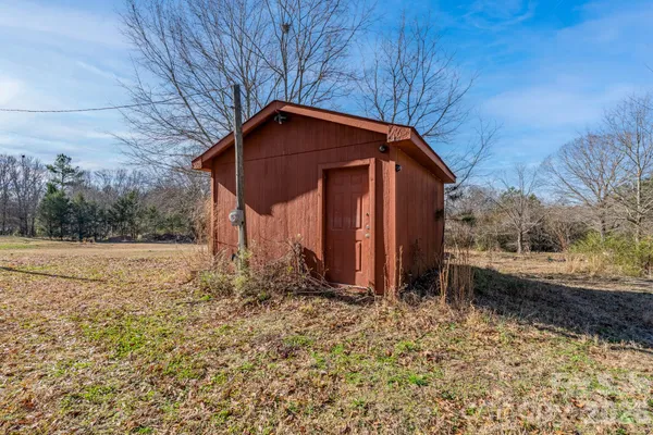 a backyard of a house with a table and chairs