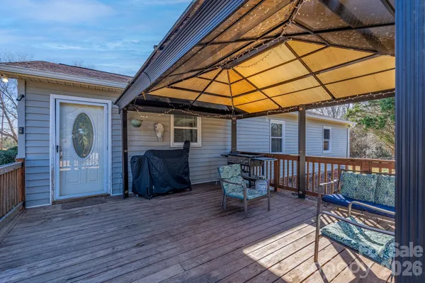 a balcony with furniture and wooden floor