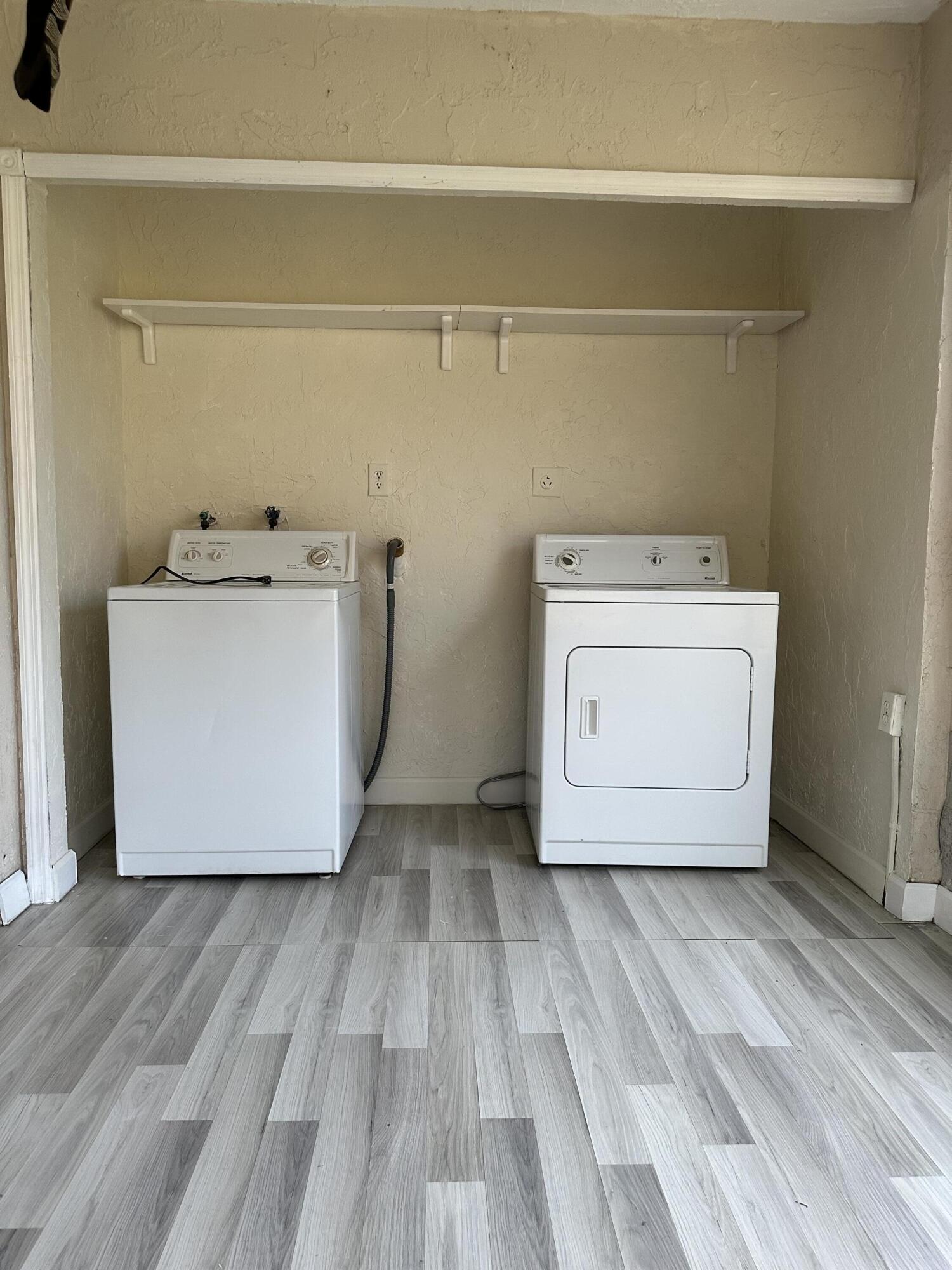 9370 Southwest 8th Street, Unit 419 Boca Raton, FL 33428 - Photo 11 of 18 a utility room with a washer and dryer
