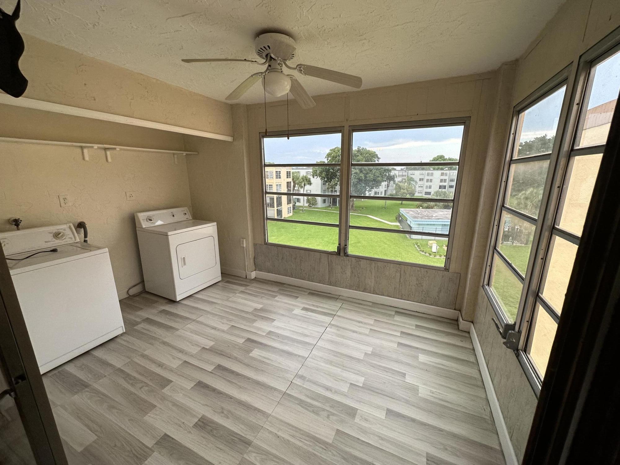 9370 Southwest 8th Street, Unit 419 Boca Raton, FL 33428 - Photo 12 of 18 a view of empty room with window and hardwood floor
