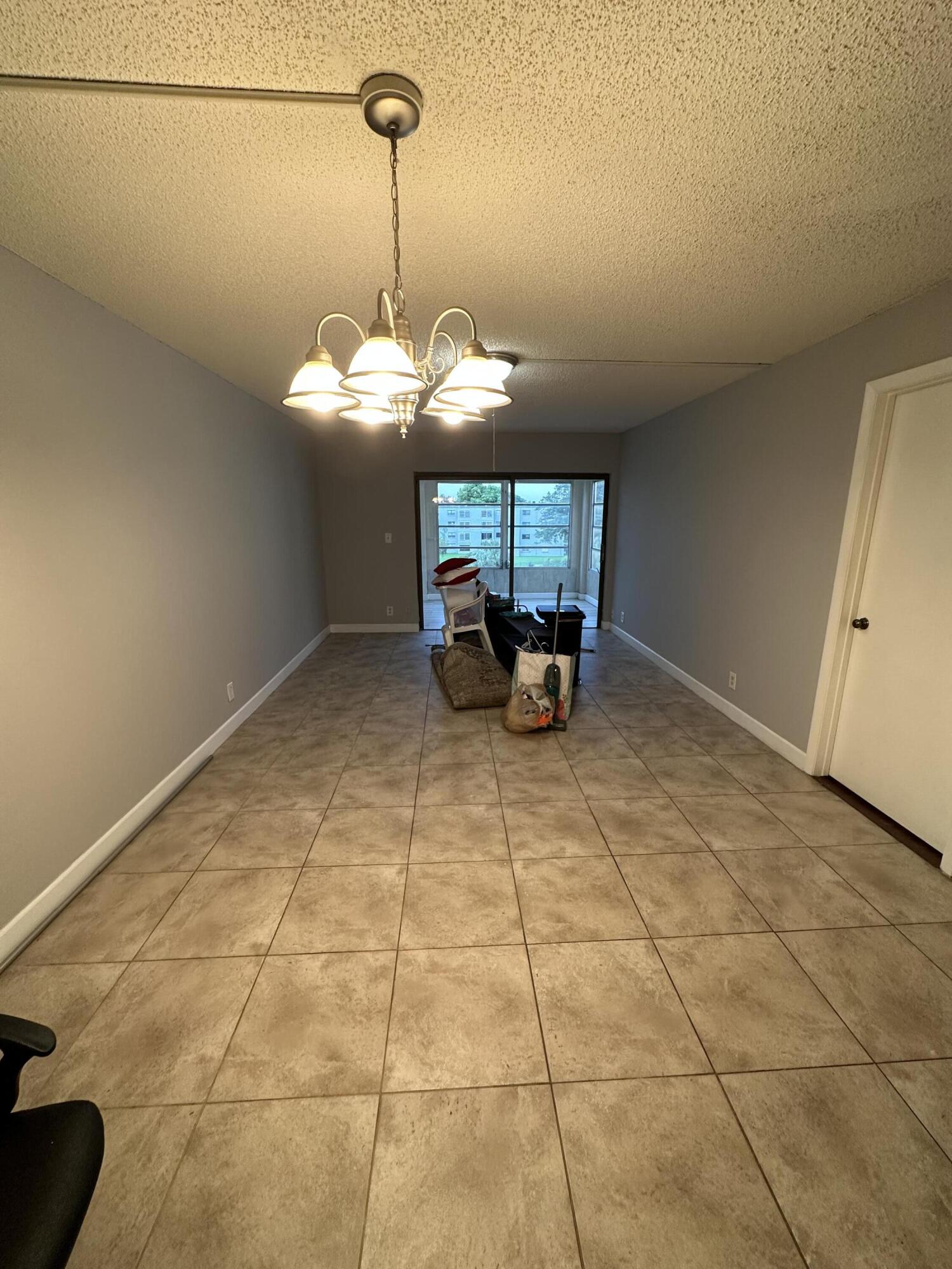 9370 Southwest 8th Street, Unit 419 Boca Raton, FL 33428 - Photo 6 of 18 a view of a room with a chandelier
