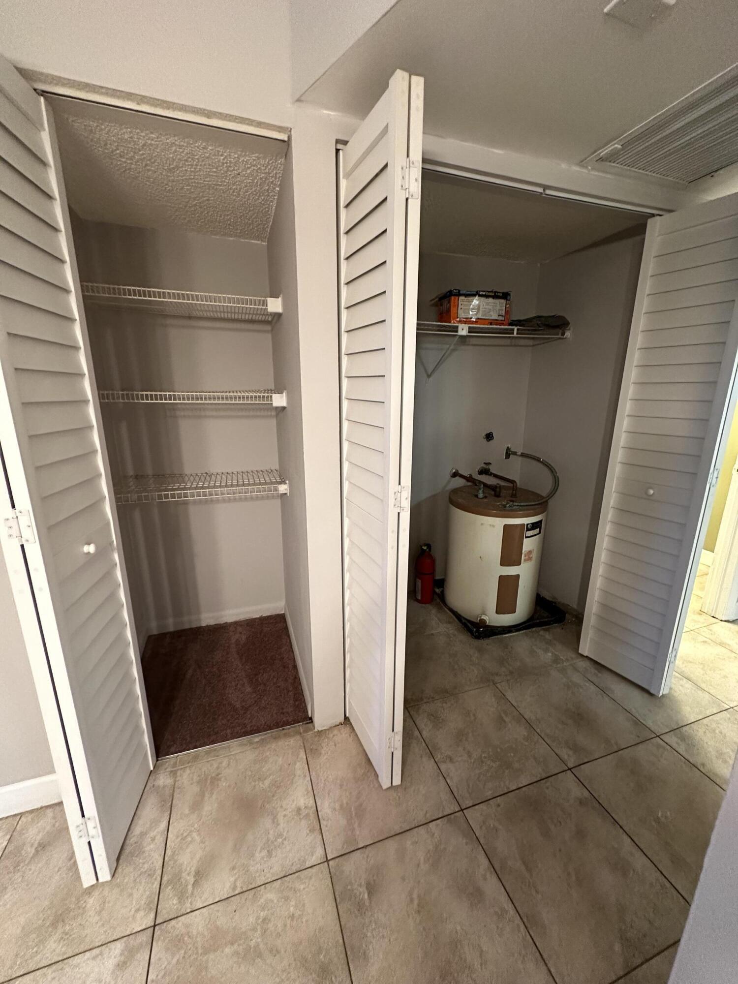 9370 Southwest 8th Street, Unit 419 Boca Raton, FL 33428 - Photo 7 of 18 a view of a refrigerator in kitchen and an empty room