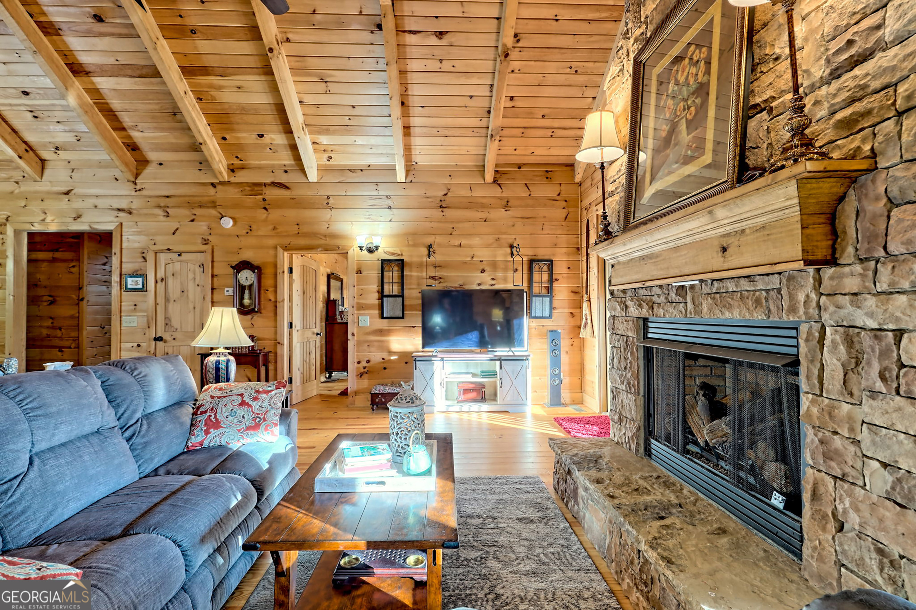 407 Blackberry Drive Rabun Gap, GA 30568 - Photo 13 of 53 a living room with furniture and a fireplace